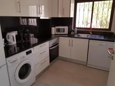 a kitchen with a washing machine and a sink at Forte Beach- Albufeira in Albufeira