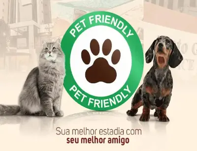 a cat and a dog sitting next to a pet friendship sign at AAA Awesome Apartamentos Albufeira in Albufeira