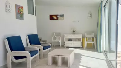 a waiting room with chairs and a table and a cabinet at Albufeira, with terrace, see views, 5 min to beach (21) in Albufeira