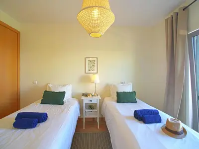 two beds in a room with blue pillows on them at Apartment Vilas Mouriscas by Interhome in Vilamoura