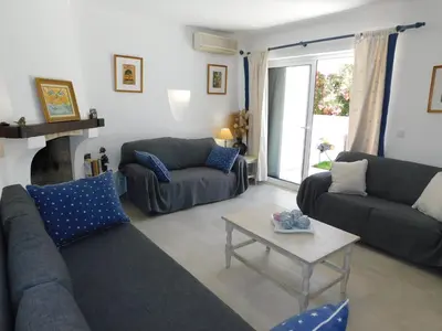 a living room with couches and a coffee table at Estrela Mar Marina Villa in Quarteira