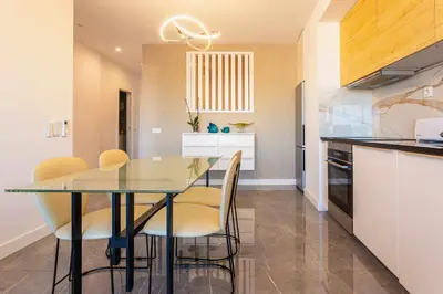 a kitchen with a dining room table and chairs at Marina View Apartment By VilamouraSun in Vilamoura