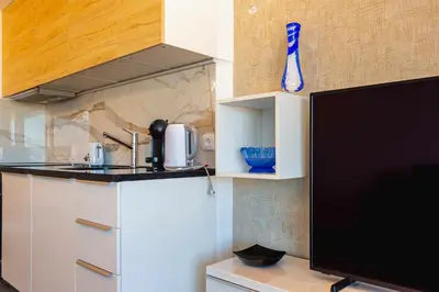a kitchen with a counter top and a tv at Marina View Apartment By VilamouraSun in Vilamoura