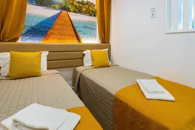 a room with two beds with a view of a boat at Marina View Apartment By VilamouraSun in Vilamoura