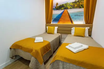 two beds in a room with a view of the ocean at Marina View Apartment By VilamouraSun in Vilamoura