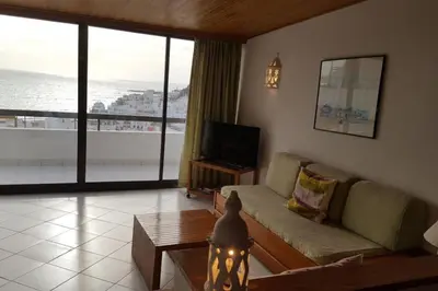 a living room with a couch and a television at Albufeira, One step to the beach (13) in Albufeira