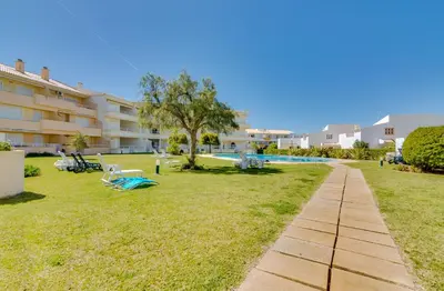 an apartment with a yard with a swimming pool at Falésia II - Nice Apartment - Vilamoura in Vilamoura