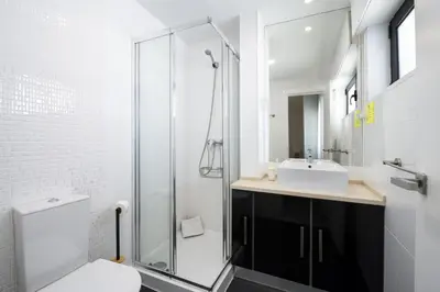 a white bedroom with a bed and a pink blanket at Palmeiras do Golfe - 3 bed. apartment - Vilamoura in Vilamoura