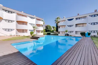 a swimming pool in front of a building at Palmeiras do Golfe - 3 bed. apartment - Vilamoura in Vilamoura