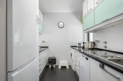 a white kitchen with a sink and a microwave at Palmeiras do Golfe - 3 bed. apartment - Vilamoura in Vilamoura