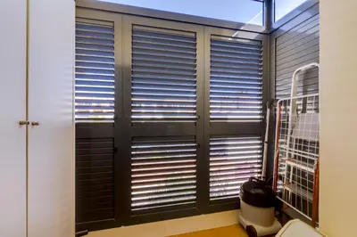 a bathroom with a large window with blinds at Paraísos do Pinhal - 2 Bedrooms - Vilamoura in Vilamoura