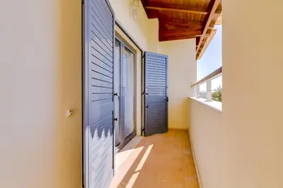 a hallway with blue doors on a house at Paraísos do Pinhal - 2 Bedrooms - Vilamoura in Vilamoura
