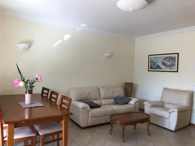 a living room with a couch and a table at Apartamentos Pomba Branca in Olhos de Água