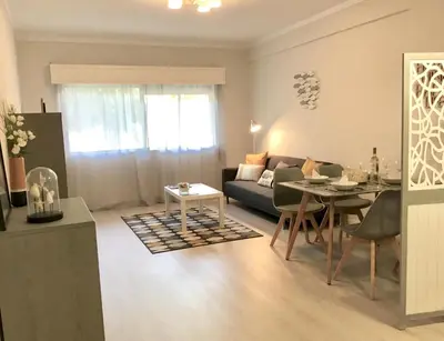 a living room with a couch and a table at Paz na Areia in Quarteira