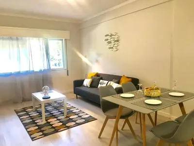 a living room with a couch and a table at Paz na Areia in Quarteira