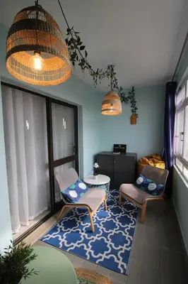 a living room with two chairs and a table at Apartamento T0 Albufeira perto do Centro in Albufeira