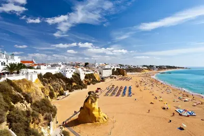 a view of a beach with people and the ocean at Townhouse N7 - Albufeira in Albufeira