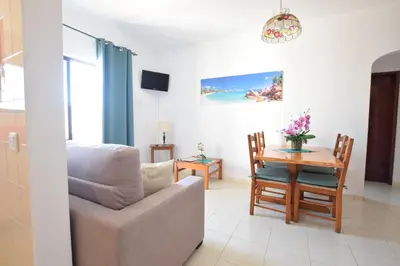 a living room with a couch and a table at Apartamentos Carruna in Albufeira