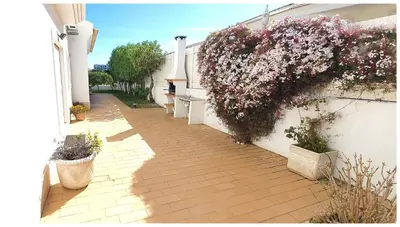 an alley with flowers on the side of a building at Casa do Mar by Laranjal Rentals in Albufeira