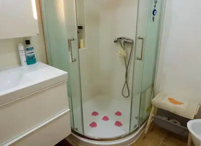 a shower with a glass door in a bathroom at Casa Mimi in Faro