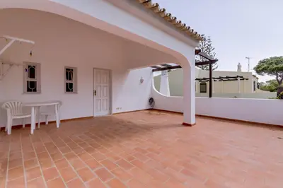 an empty patio with a table and chairs on a house at Vila Caracas - V3 - Vilamoura in Vilamoura