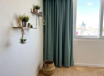 a room with a window with green curtains and a basket at Sunset Bacara - Near Vilamoura Marina in Vilamoura