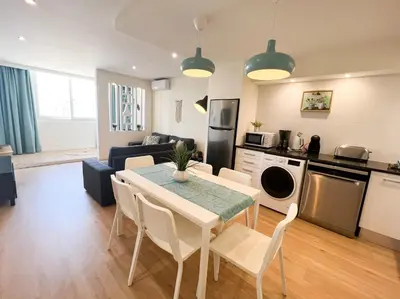 a kitchen and living room with a table and chairs at Sunset Bacara - Near Vilamoura Marina in Vilamoura