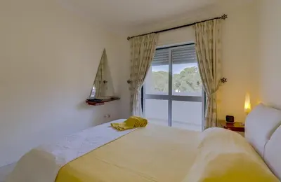 a tree in a yard next to a street at Pinhal do Golfe - 2 Bedrooms - Vilamoura in Vilamoura