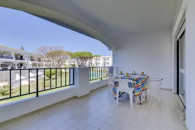 a large balcony with a table and chairs on it at Pinhal do Golfe - 2 Bedrooms - Vilamoura in Vilamoura