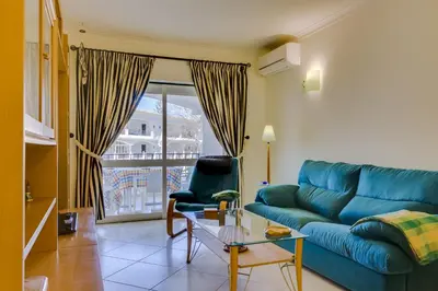 a balcony with a table and chairs and a view at Pinhal do Golfe - 2 Bedrooms - Vilamoura in Vilamoura