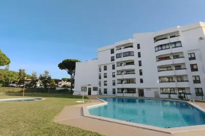 a building with a swimming pool in front of a building at Ténis Golf Mar CD 14 - Clever Details in Vilamoura