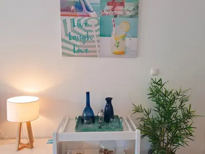 a white table with vases and a lamp on it at Ténis Golf Mar CD 14 - Clever Details in Vilamoura