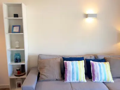 a couch with pillows on it in a living room at Ténis Golf Mar CD 14 - Clever Details in Vilamoura