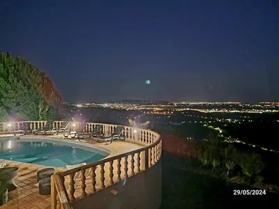a swimming pool on a balcony at night at Elegant family house in Loulé with private pool in Loulé
