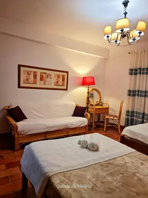 a living room with two beds and a lamp at Elegant family house in Loulé with private pool in Loulé