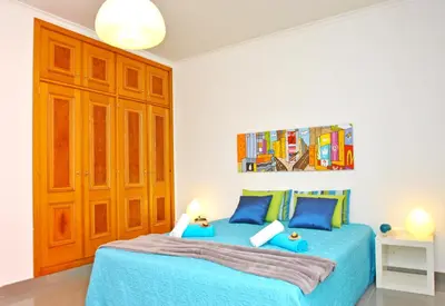 a bedroom with two beds with blue sheets at Apartment Ipanema 3 by Algarve Vacation in Albufeira