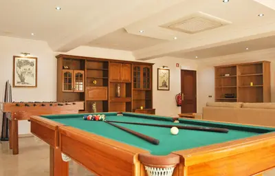 a living room with a pool table in it at Villa Nespereira by Algarve Vacation in Albufeira