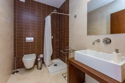 a bathroom with a white sink and a toilet at Villa Ocean Pine in Albufeira