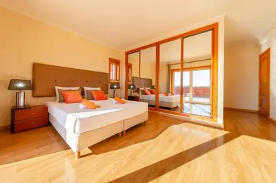 a bedroom with two beds and a large window at Villa California by Algarve Vacation in Albufeira