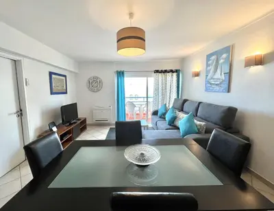 a living room with a couch and a table at Mar apartment wonderful view - Quarteira in Quarteira
