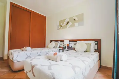 a bedroom with two beds with towels on them at Villa Honolulu by Algarve Vacation in Albufeira