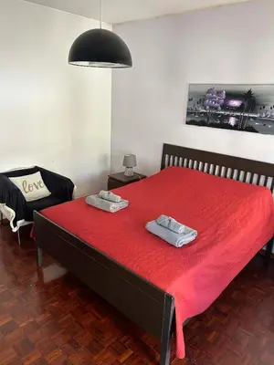 a bedroom with a bed with two towels on it at CASA JUDITE in Faro