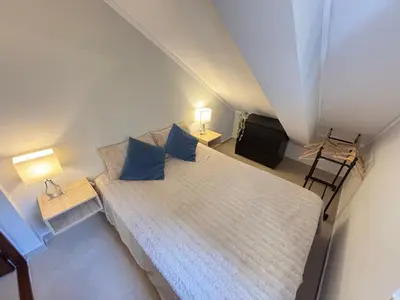 a bedroom with a bed with blue pillows at The Marina Plaza Vilamoura in Vilamoura