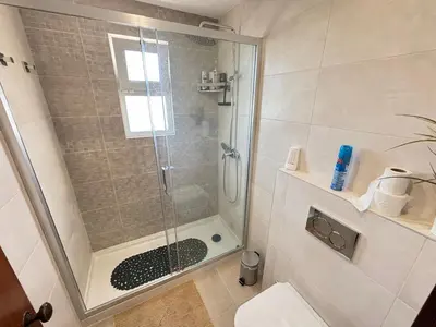 a bathroom with a shower with a glass door at The Marina Plaza Vilamoura in Vilamoura