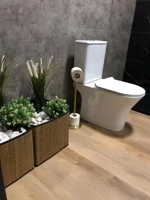 a bathroom with a toilet and two potted plants at Modern Top Floor Apartment 60m2 - Balcony with Pool & Sea View - Vilamoura in Vilamoura