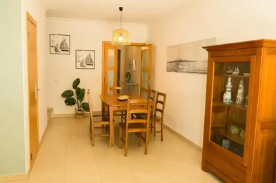 a dining room with a wooden table and chairs at Sunny Condo-Pool by Algarve Dream Holidays in Albufeira