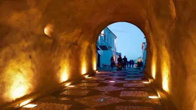 an alleyway with people walking down a street at Sunny Condo-Pool by Algarve Dream Holidays in Albufeira