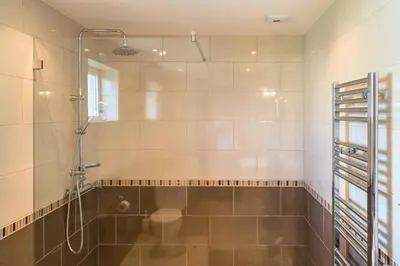 a bathroom with a shower with a glass door at Casa Laranja Three bedroom Villa in Loulé