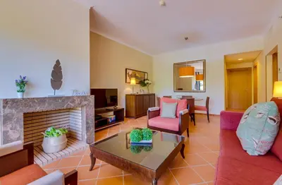 a living room with a couch and a fireplace at AL - Apartamento Vila Sol F5 Top Floor in Quarteira