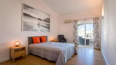 a bedroom with a bed and a large window at Sienna in Vale do Lobo